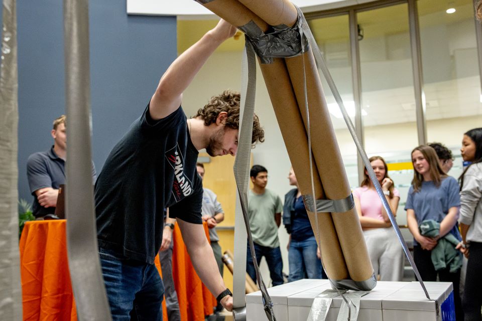 School of Science and Engineering students construct a bridge out of cardboard and duct tape during the SSE Innovation Challenge with industry partner TWM on November 13, 2024. 