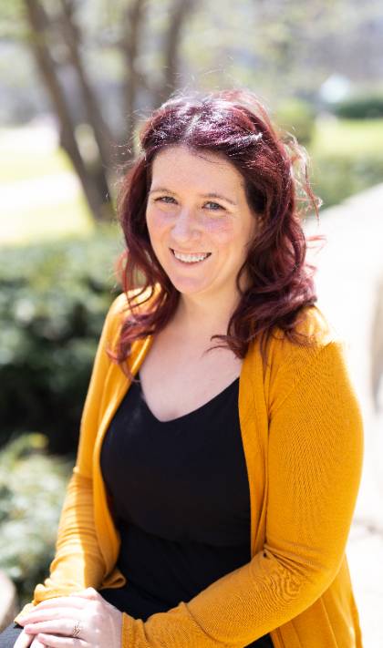 A portrait of Kelsey-Mesmer wearing a blue dress