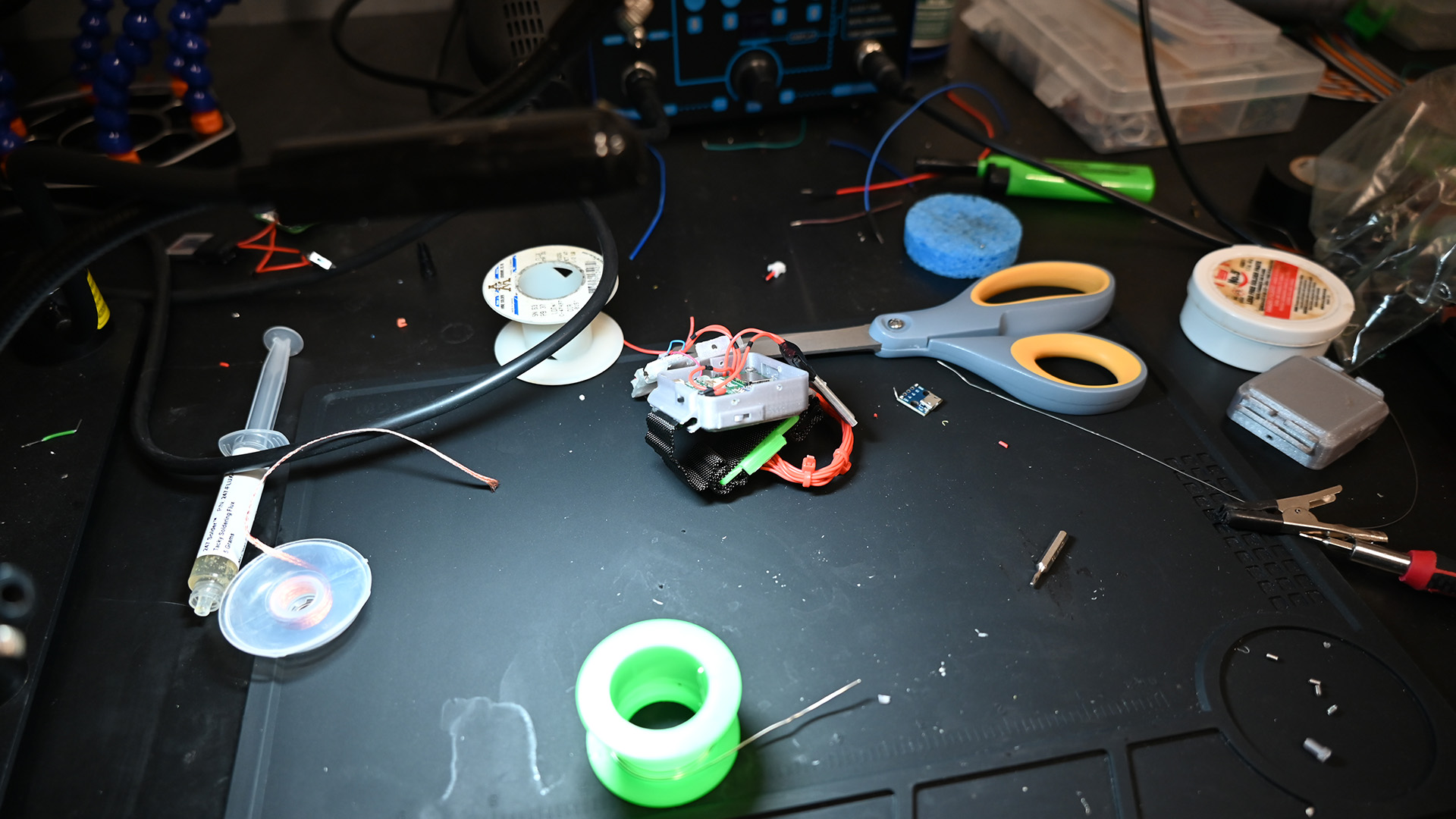 An electronic device sitting on a black workbench in the CHROME Lab.