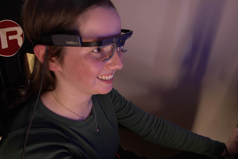 Teen wearing eye-tracking glasses worn by participants during driving simulation training and assessments.